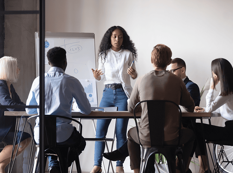 Marketing leader presenting a growth plan to her team, showing what a fractional CMO does to get marketing actually working