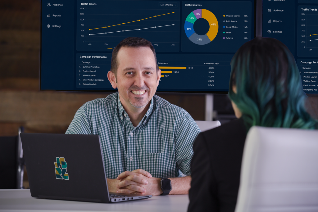Scott Everhart reviewing campaign performance data with a client as he leads JSRG Ventures' fractional CMO practice